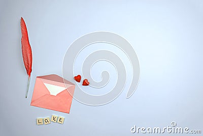 Pink envelop with love letter on pastel flat lay background, valentine's day red hearts and feather composition, feelings concept Stock Photo