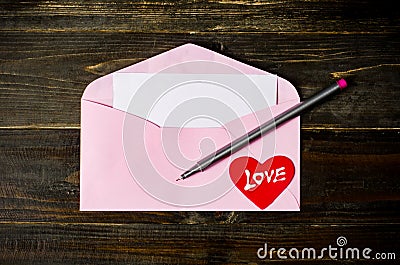 Pink envelop on wooden background Stock Photo