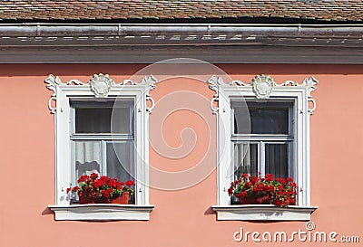 Pink facade with stucco decoration around the windows Stock Photo