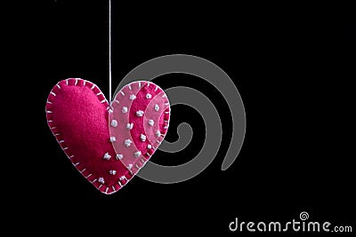 Pink felt heart on the rope. Handmade isolate on black background Stock Photo