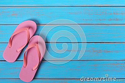 Pink flip flop sandals old summer beach wood background painted blue Stock Photo