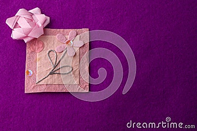 Pink floral bloom design on handmade paper on purple backdrop with copy space Stock Photo