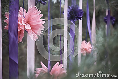 Pink flower with ribbons in a coniferous forest. Stock Photo