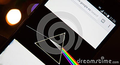 Pink Floyd`s Dark Side of the Moon disc on a mobile phone with defocused Bokeh effect background Editorial Stock Photo