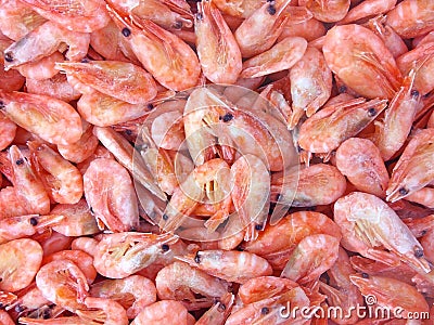 Pink frozen shrimps with ice. Uncooked seafood background Stock Photo