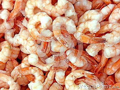 Pink frozen shrimps with ice. Uncooked seafood background Stock Photo