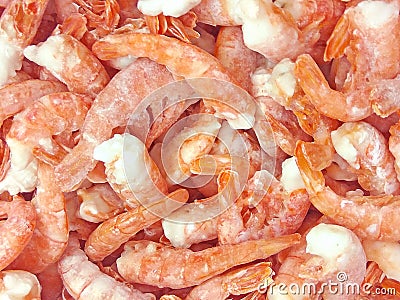 Pink frozen shrimps with ice. Uncooked seafood background Stock Photo