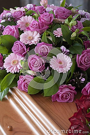 Pink Funeral flowers on a casket Stock Photo