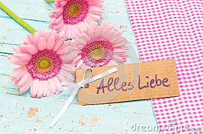 Card with german text, Alles Liebe, means love and pink flowers for Valentines or Mothers Day Stock Photo