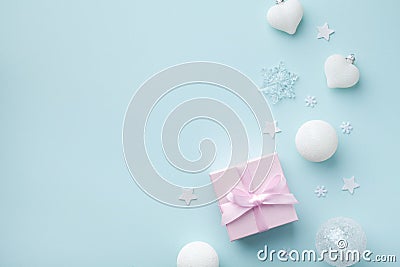 Pink gift box and white Christmas decorations on mint pastel background. Christmas or New year holiday card top view. Flat lay Stock Photo