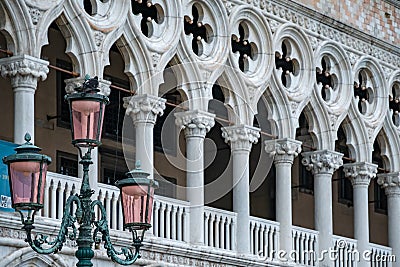 Pink glassed lamppost before the loggia of the Doge`s Palace in Venice, Italy Stock Photo