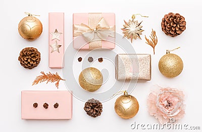 Pink and gold christmas gifts isolated on white background. Wrapped xmas boxes, christmas ornaments, baubles and pine cones. Stock Photo