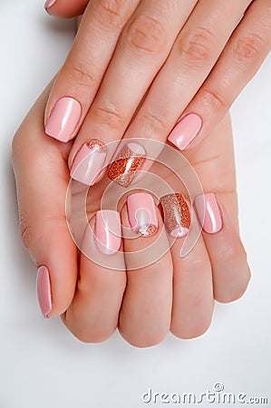 Pink gold manicure on short square nails Stock Photo