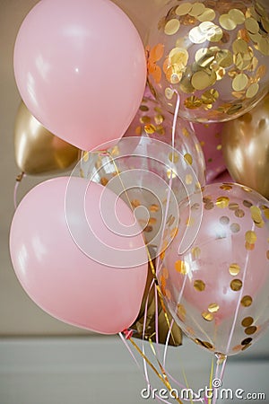 Pink and golden balloons with text `it`s a girl` gender reveal party. Stock Photo