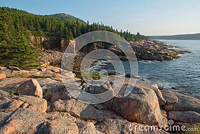 Pink Granite Rocks and cliffs overlooking a quite secluded cove Stock Photo