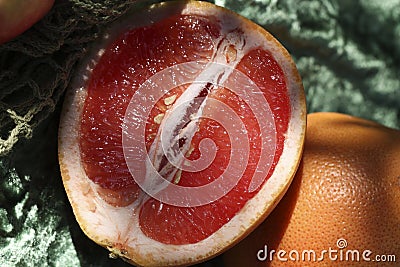 pink grapefruit on green background. summer picnic style. Stock Photo