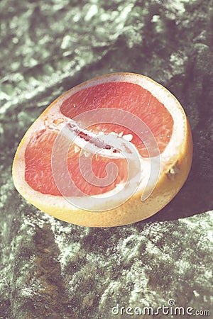 pink grapefruit on green background. summer picnic style. Stock Photo