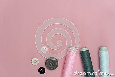 Pink grey white tread and button for sewing or embroidery on background fashion and cloth industry Stock Photo