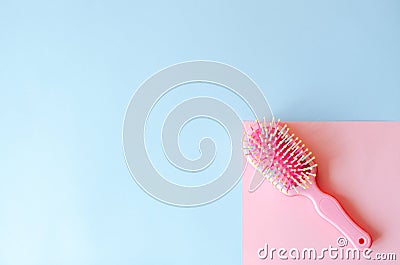 Pink hairbrush on a pink-blue background Stock Photo