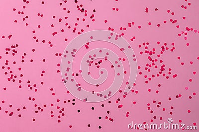 Pink hearts glitter on pink backdrop. Decorative Christmas and New Year party background. Festive template. Greeting Stock Photo