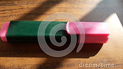 Pink highlighter marker on a wooden table Stock Photo