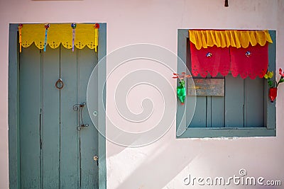 Pink house facade with bluish gray door and window. Stock Photo