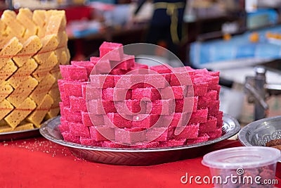 Pink Indian sweet desert cakes for sale at Thaipusam festival Stock Photo