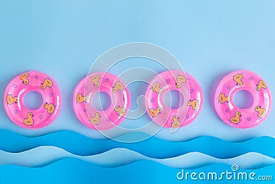 Pink inflatable pool floats and waves made of paper abstract Stock Photo