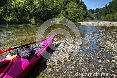 Pink Kayak Resting on on the Banks of the Yakima River Stock Photo