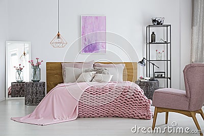 Knit blanket in feminine bedroom Stock Photo