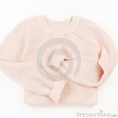 Pink knit sweater flat lay on white background. Stock Photo