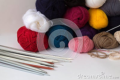 Colours balls of yarn and knitting needles on white backgroundhite background Stock Photo