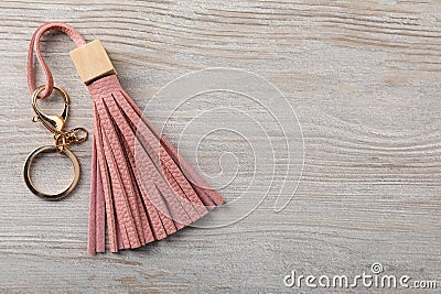 Pink leather keychain on light wooden background, top view. Space for text Stock Photo