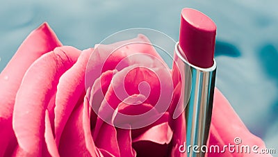 Pink lipstick and rose flower on liquid background, waterproof glamour make-up and lip gloss cosmetics product for luxury beauty Stock Photo