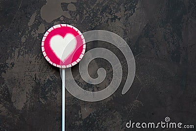 Pink lollipop with white heart top view Stock Photo
