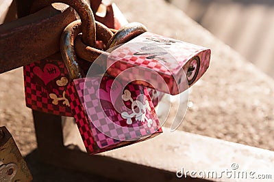 Pink love locks with skulls and crossbones Stock Photo