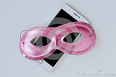 Pink mask on mobile phone - Concept of privacy, security and anonymity of mobile phone for women Stock Photo