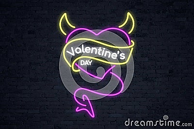 Pink neon devil heart `Valentine`s Day` with horns and tail Stock Photo