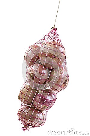 Pink onion hanging packed in a red net bag on white background Stock Photo