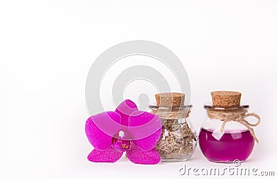 Pink orchid and two glass bottles on a white background. Spa concept. Cosmetic bottles. Ecological natural cosmetics. Copy space. Stock Photo