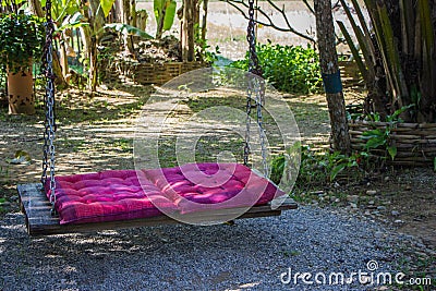 Pink pad on wood swing Stock Photo