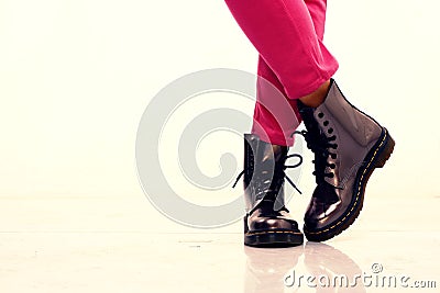 Pink pants and shiny leather boots Stock Photo