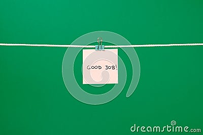 Pink paper sheet on the string with text Good Job Stock Photo