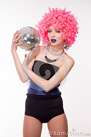 Pink party girl holding silver ball Stock Photo