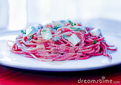 Pink pasta on a white plate Stock Photo