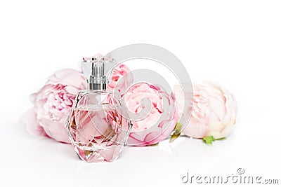 Pink perfume bottle with flowers on light background. Perfumery, cosmetics, fragrance collection Stock Photo