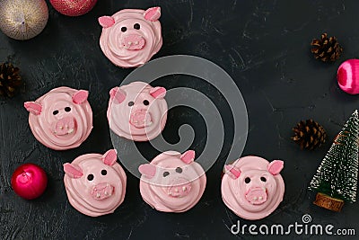 Pink pig cupcakes - homemade cupcakes decorated with protein cream and marshmallow shaped funny piggies Stock Photo