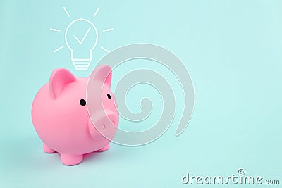 Pink piggy bank with digital hologram light bulp on blue background. Bussiness innovation, brainstorming, inspiration and solution Stock Photo