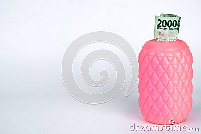 a pink piggy bank with twenty thousand rupiah n white background Editorial Stock Photo