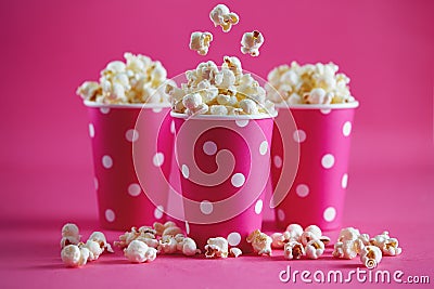 Pink polka dot paper cups with tasty popcorn. Stock Photo